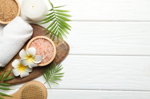 Spa products and candles on wooden table